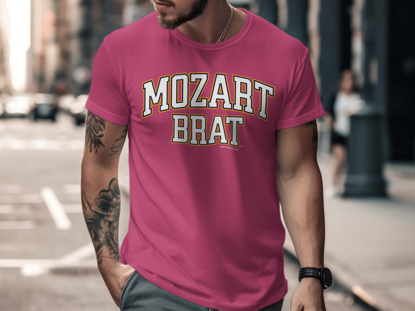Pink t-shirt with white and yellow text "MOZART BRAT" and "Another Spoiled Brat™".