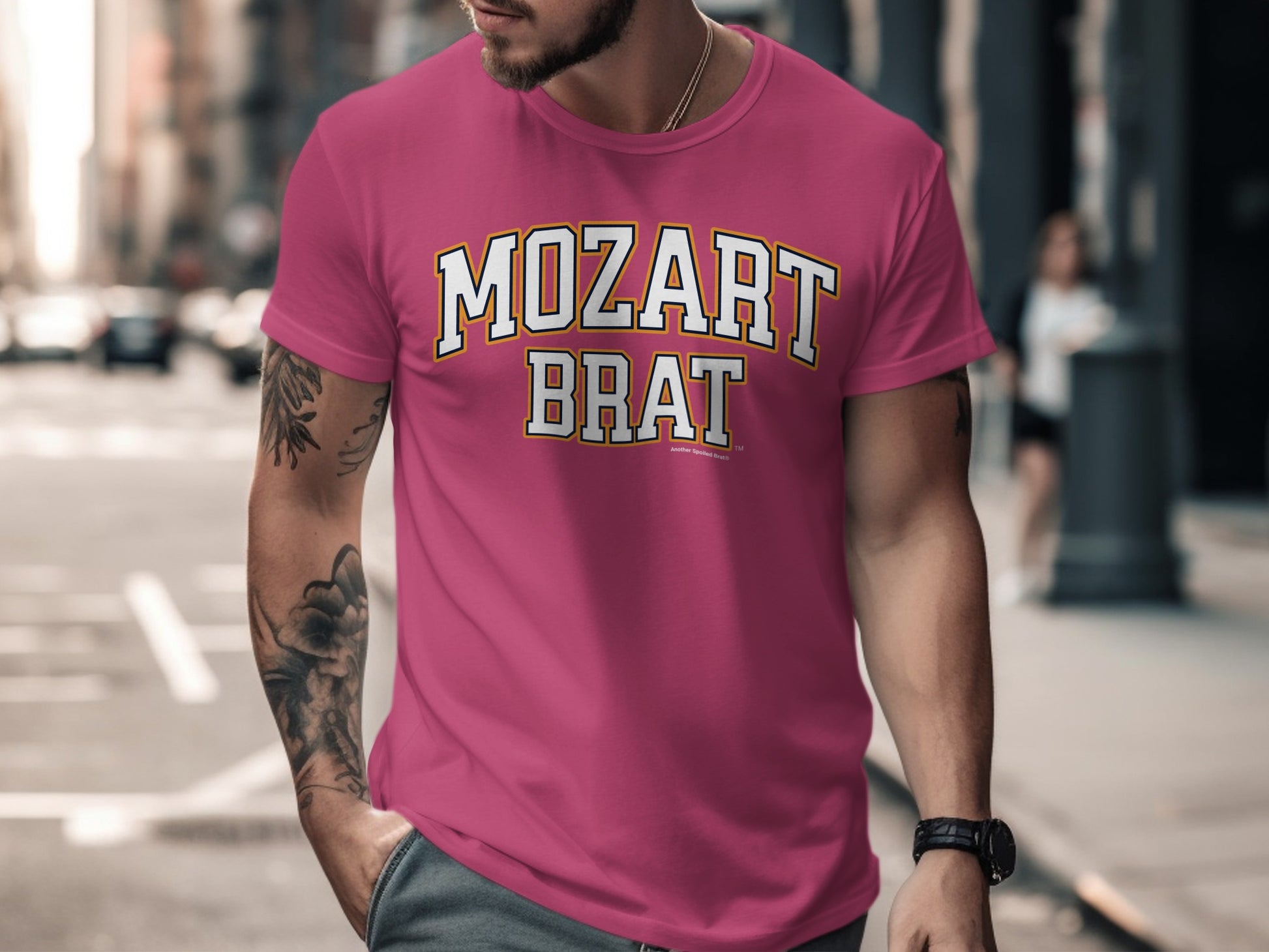 Pink t-shirt with white and yellow text "MOZART BRAT" and "Another Spoiled Brat™".