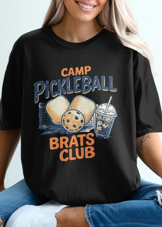 Black t-shirt with "Camp Pickleball Brats Club" text and graphic.