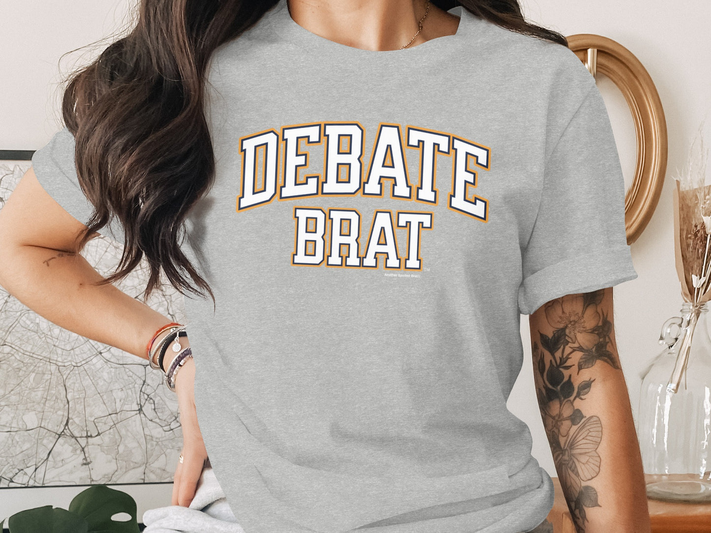 Grey t-shirt with "DEBATE BRAT" text in collegiate font style.