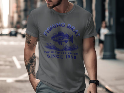 Gray t-shirt with "FISHING BRAT THE ULTIMATE CATCH SINCE 1956" and fish graphic.