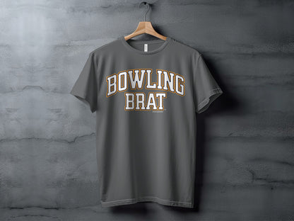 Gray t-shirt with "BOWLING BRAT" text in arched white and gold outline.