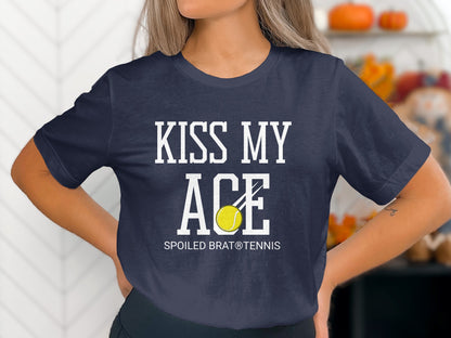 Navy t-shirt with "KISS MY ACE" and a tennis ball, "SPOILED BRAT® TENNIS" below.