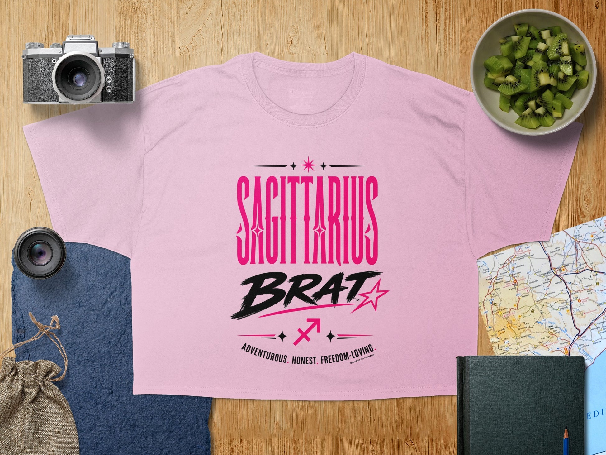Pink t-shirt with "SAGITTARIUS BRAT" and constellation design.